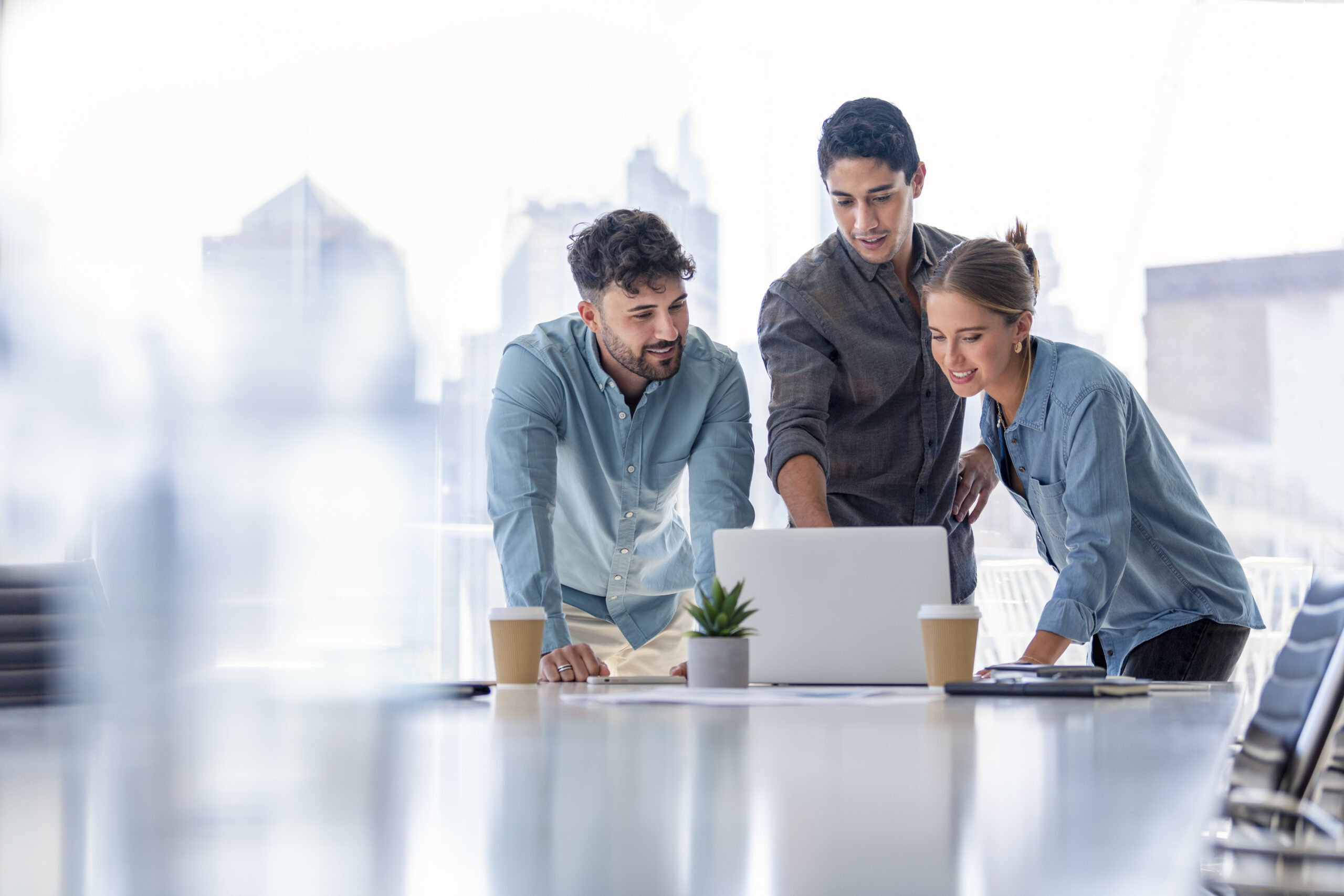 three people listening and taking notes